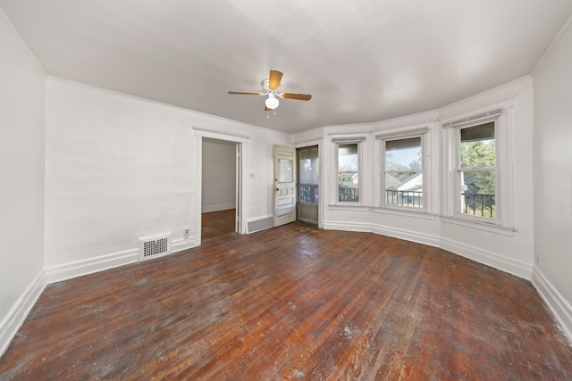 spare room with dark hardwood / wood-style floors, ceiling fan, and ornamental molding