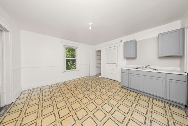 kitchen with gray cabinetry and sink