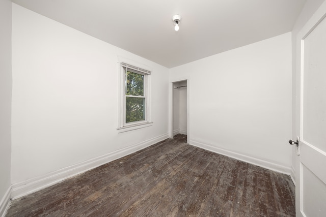 unfurnished bedroom with dark wood-type flooring