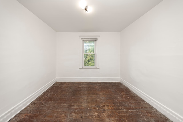 spare room with dark hardwood / wood-style flooring