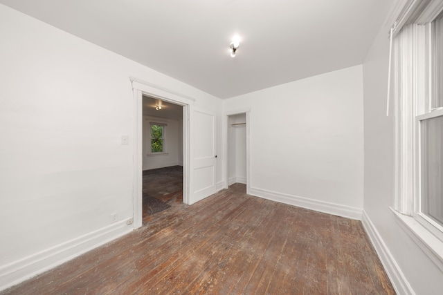 empty room featuring dark wood-type flooring