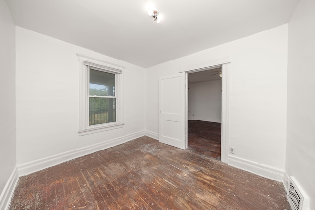 spare room featuring dark hardwood / wood-style flooring