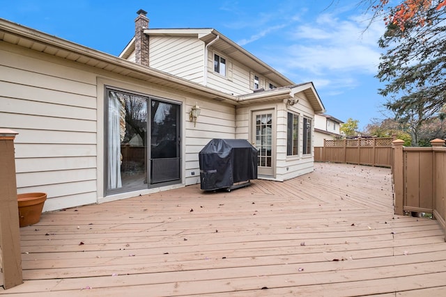 wooden terrace with a grill