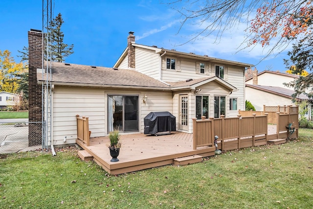 back of house with a wooden deck and a yard