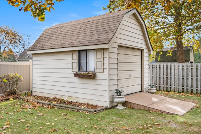 view of outbuilding featuring a lawn