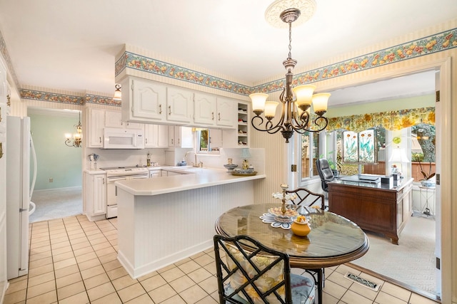 kitchen with an inviting chandelier, white cabinets, kitchen peninsula, white appliances, and light tile patterned floors