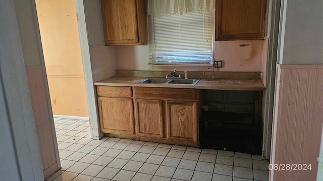 kitchen featuring light tile patterned floors and sink