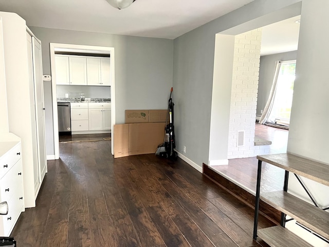 kitchen with dishwasher, white cabinetry, and dark wood-type flooring