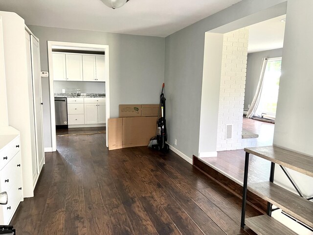 6015 S Stoney Lake Rd, Jackson, MI 49201 - hallway featuring dark wood-style floors and baseboards