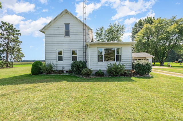 view of side of home featuring a yard