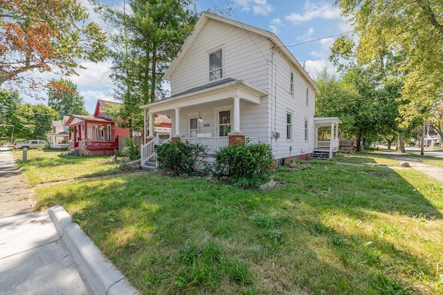 view of front of property featuring covered porch and a front lawn