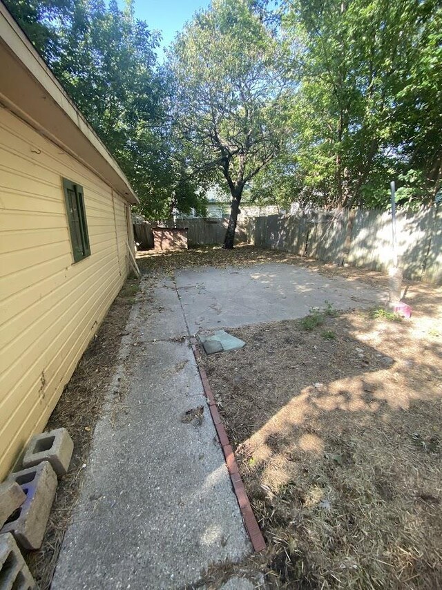 836 Victoria Ave, Flint, MI 48507 - fenced backyard with a patio area