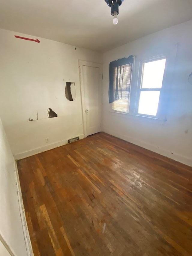 spare room with dark hardwood / wood-style floors