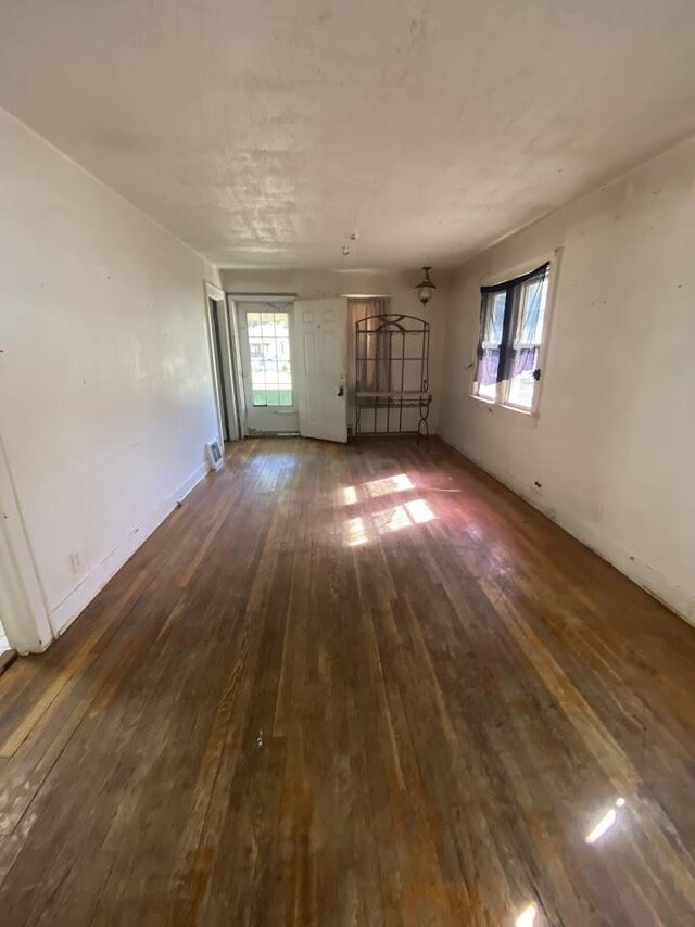 836 Victoria Ave, Flint, MI 48507 - empty room with dark wood-type flooring and baseboards