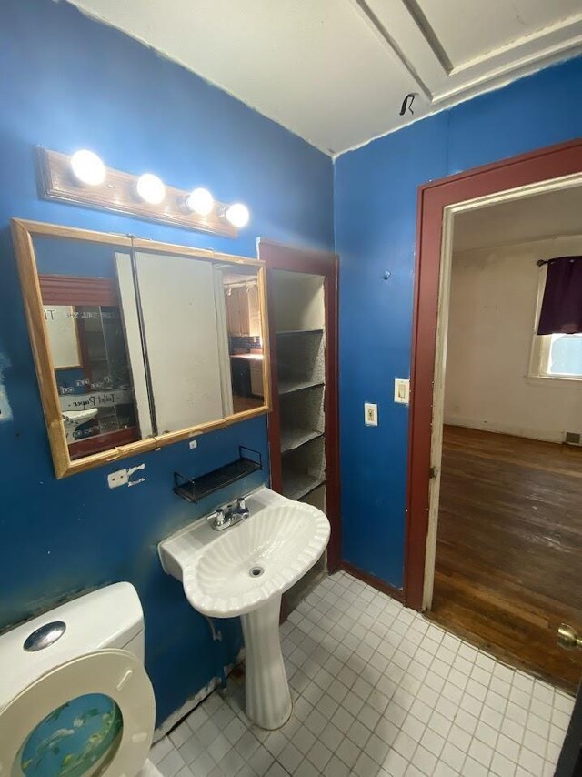 836 Victoria Ave, Flint, MI 48507 - half bath with lofted ceiling, toilet, and tile patterned floors