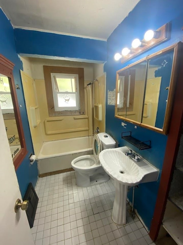 bathroom featuring tile patterned flooring, shower / bath combination, and toilet