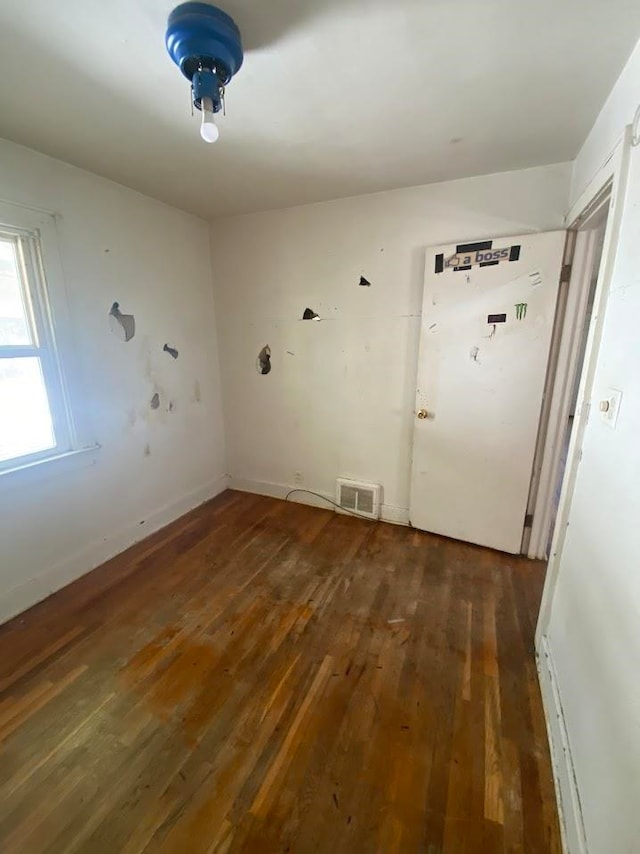 spare room with dark hardwood / wood-style flooring