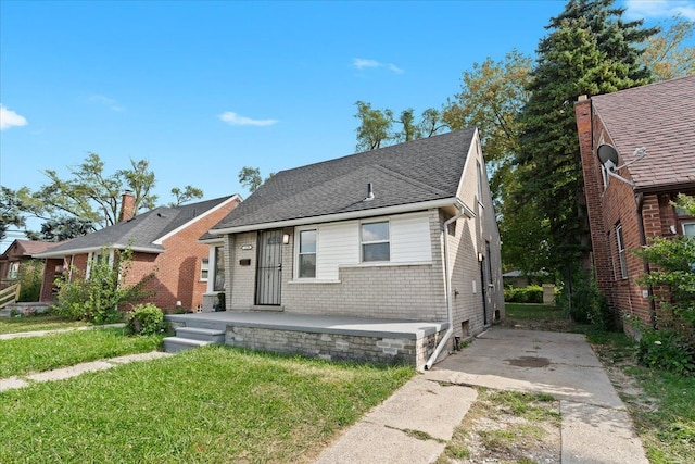 bungalow-style home featuring a front yard