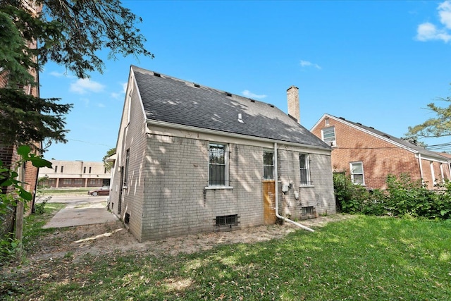 back of property featuring a lawn