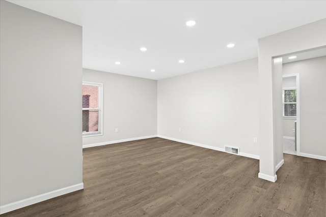 unfurnished room with dark hardwood / wood-style flooring