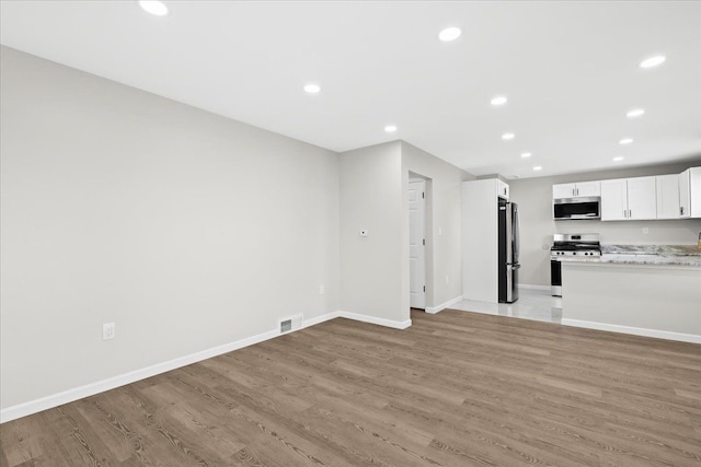 unfurnished living room featuring light wood-type flooring