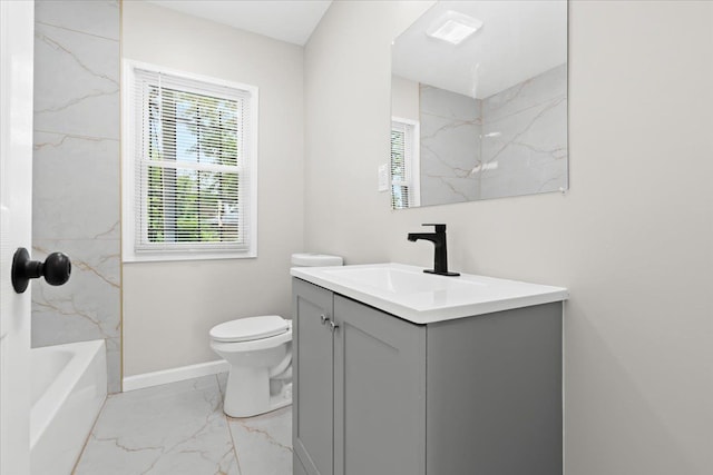 full bathroom featuring tiled shower / bath, vanity, and toilet