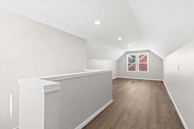 bonus room featuring dark hardwood / wood-style floors and vaulted ceiling