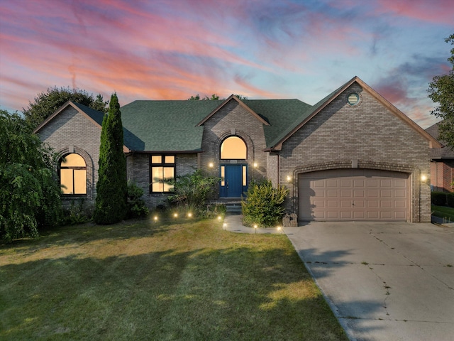 french country home featuring a garage and a lawn