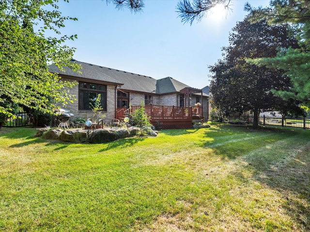 view of front facade featuring a front yard and a deck