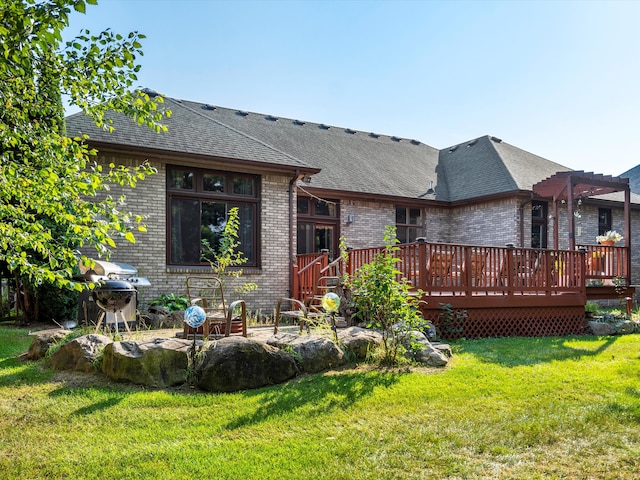 back of property featuring a lawn, a pergola, and a wooden deck