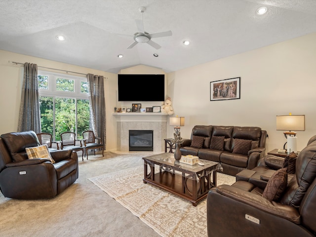 living room with ceiling fan, light colored carpet, lofted ceiling, and a textured ceiling