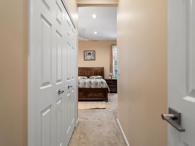 hallway featuring light colored carpet