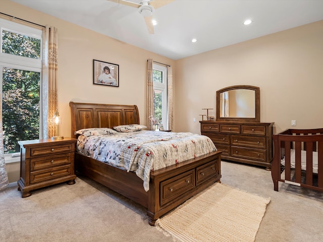 bedroom featuring ceiling fan and light colored carpet