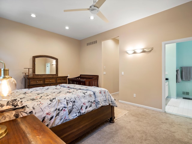 carpeted bedroom with connected bathroom and ceiling fan