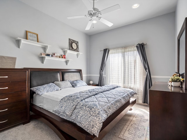 bedroom featuring light carpet and ceiling fan