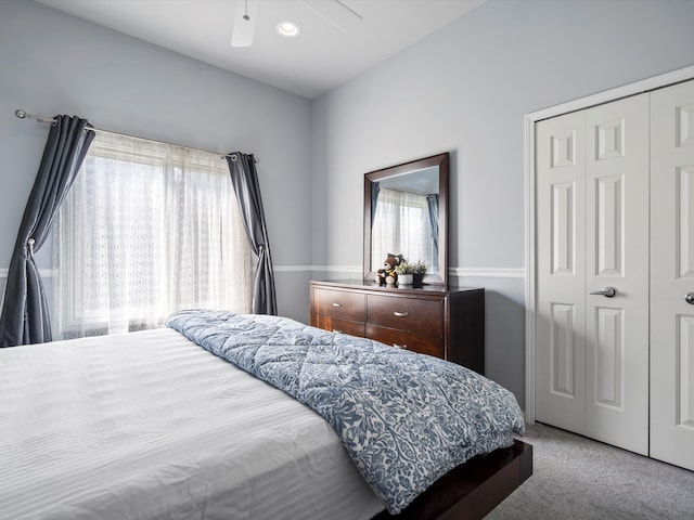 bedroom featuring ceiling fan, a closet, and carpet