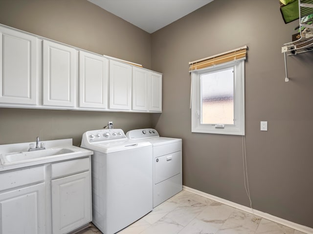 clothes washing area with sink, cabinets, and independent washer and dryer