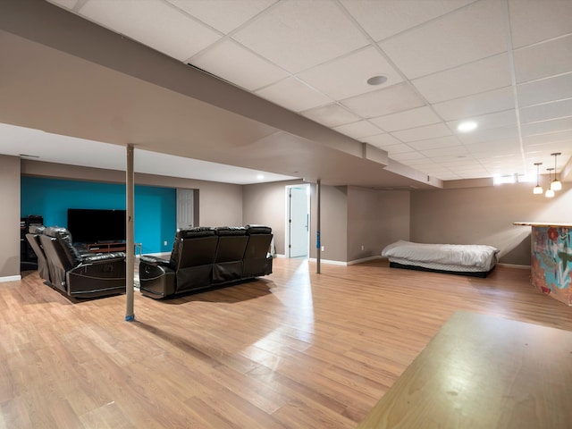 bedroom with a paneled ceiling and light hardwood / wood-style floors