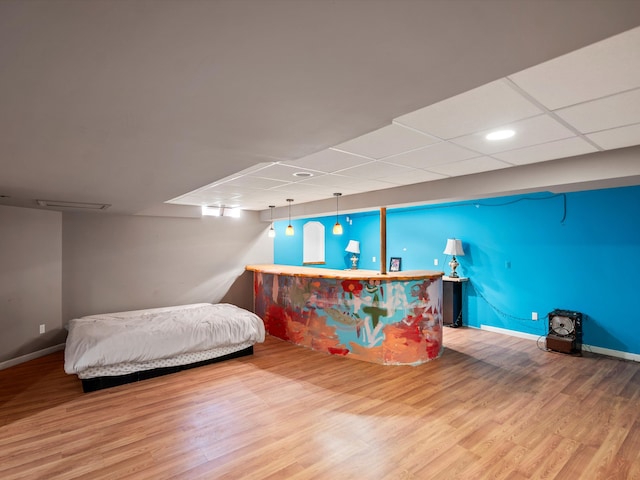 bedroom featuring a paneled ceiling and hardwood / wood-style floors