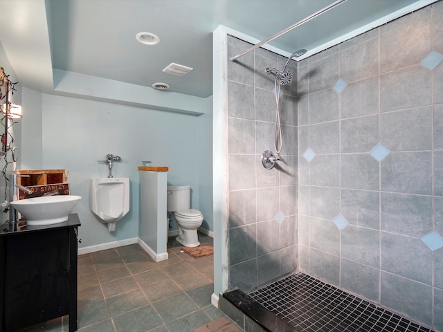 bathroom with vanity, toilet, and tiled shower