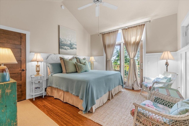876 S Beach, Pentwater, MI 49449 - bedroom featuring wood finished floors, wainscoting, a decorative wall, lofted ceiling, and access to exterior