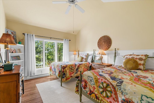 876 S Beach, Pentwater, MI 49449 - bedroom featuring baseboard heating, wood finished floors, a ceiling fan, and high vaulted ceiling