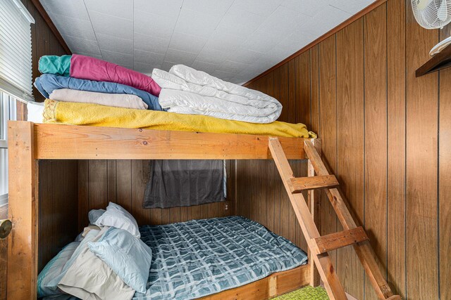 76 Sundago Park St, Hastings, MI 49058 - bedroom with wooden walls and carpet floors