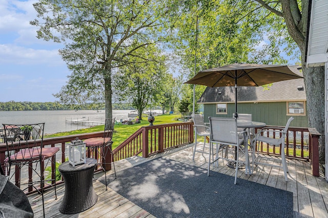 76 Sundago Park St, Hastings, MI 49058 - wooden terrace featuring outdoor dining space, a water view, and a yard