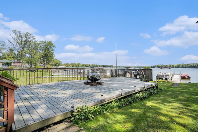 76 Sundago Park St, Hastings, MI 49058 - deck with a lawn, a fire pit, a water view, and a boat dock