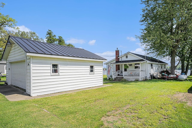 76 Sundago Park St, Hastings, MI 49058 - exterior space with covered porch, an outbuilding, a detached garage, and metal roof