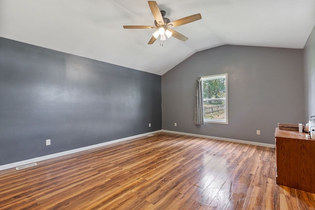 additional living space featuring hardwood / wood-style flooring, ceiling fan, and lofted ceiling