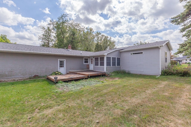 rear view of house with a yard and a wooden deck