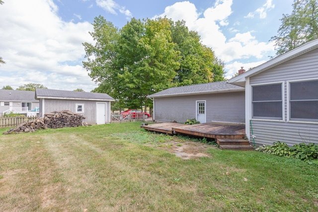 view of yard with a storage shed and a deck