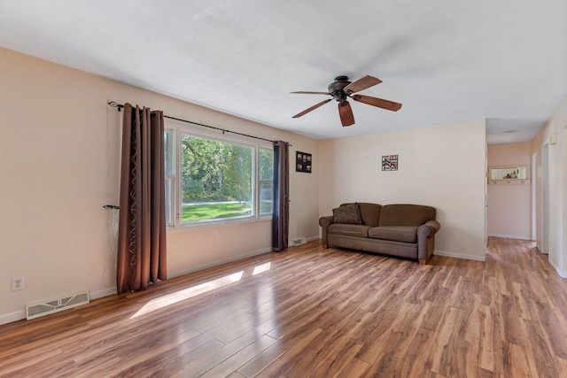 living room with ceiling fan and light wood-type flooring